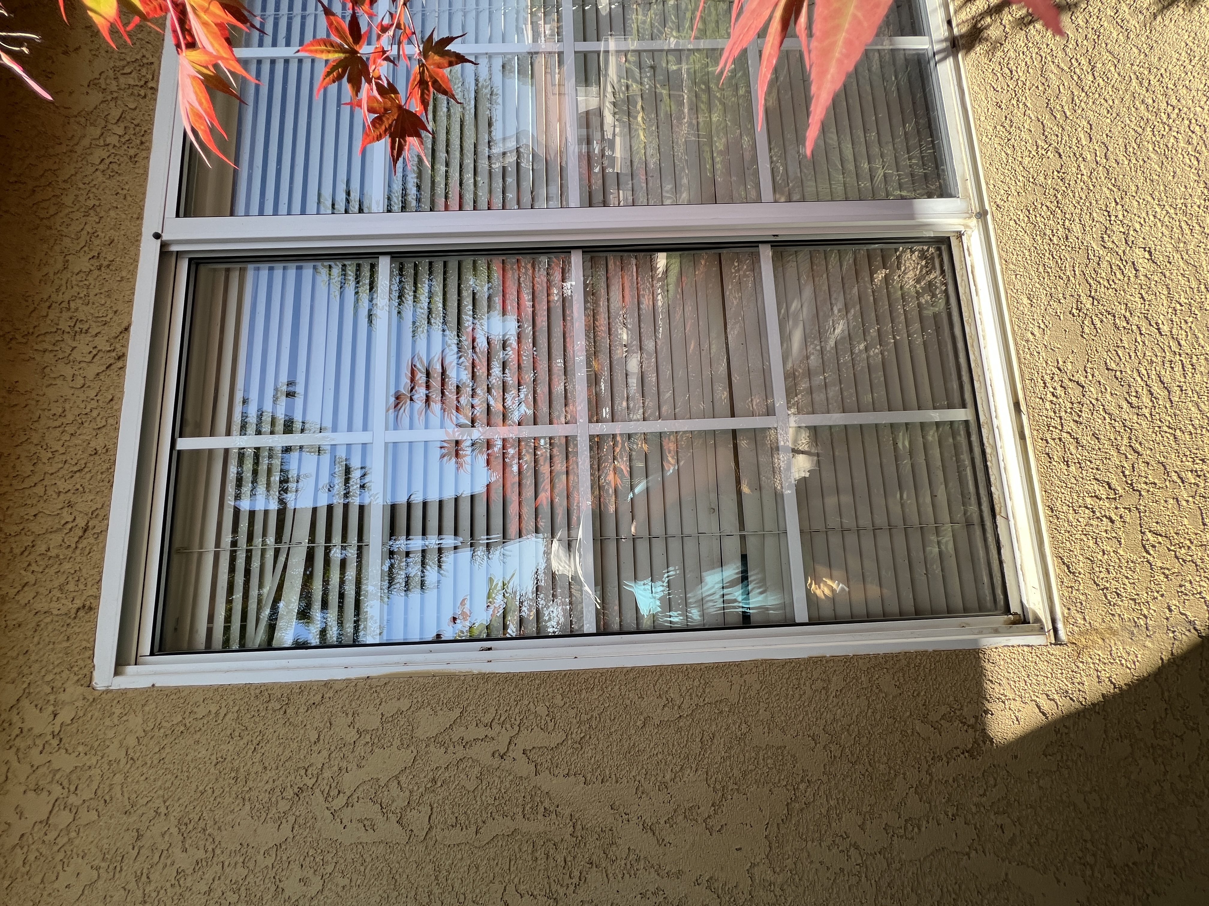 Dirty exterior window with hard water deposits before cleaning Fresno CA