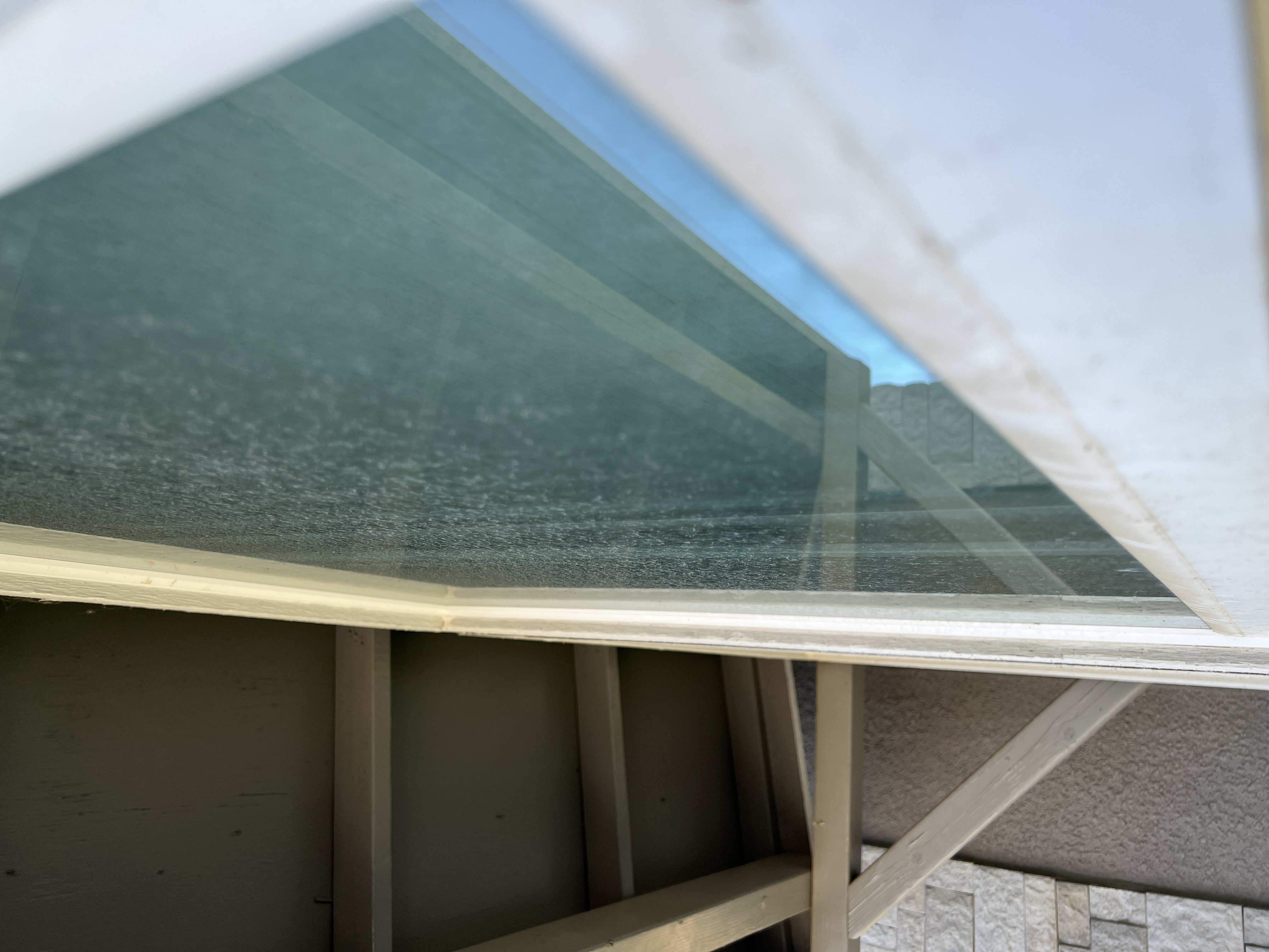 Severe hard water stains on window before removal Fresno CA